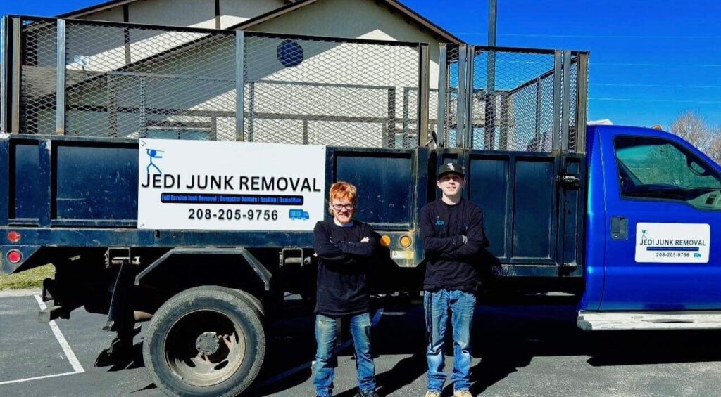 two guys in front of jedi junk removal truck dump truck