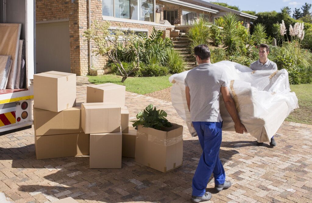 two guys carrying a couch junk removal