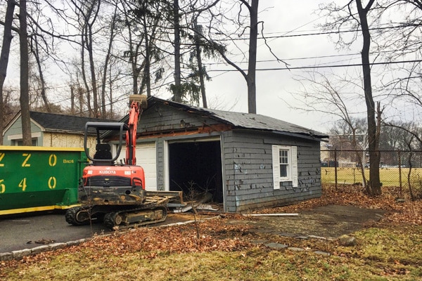 shed being torn down by tractor